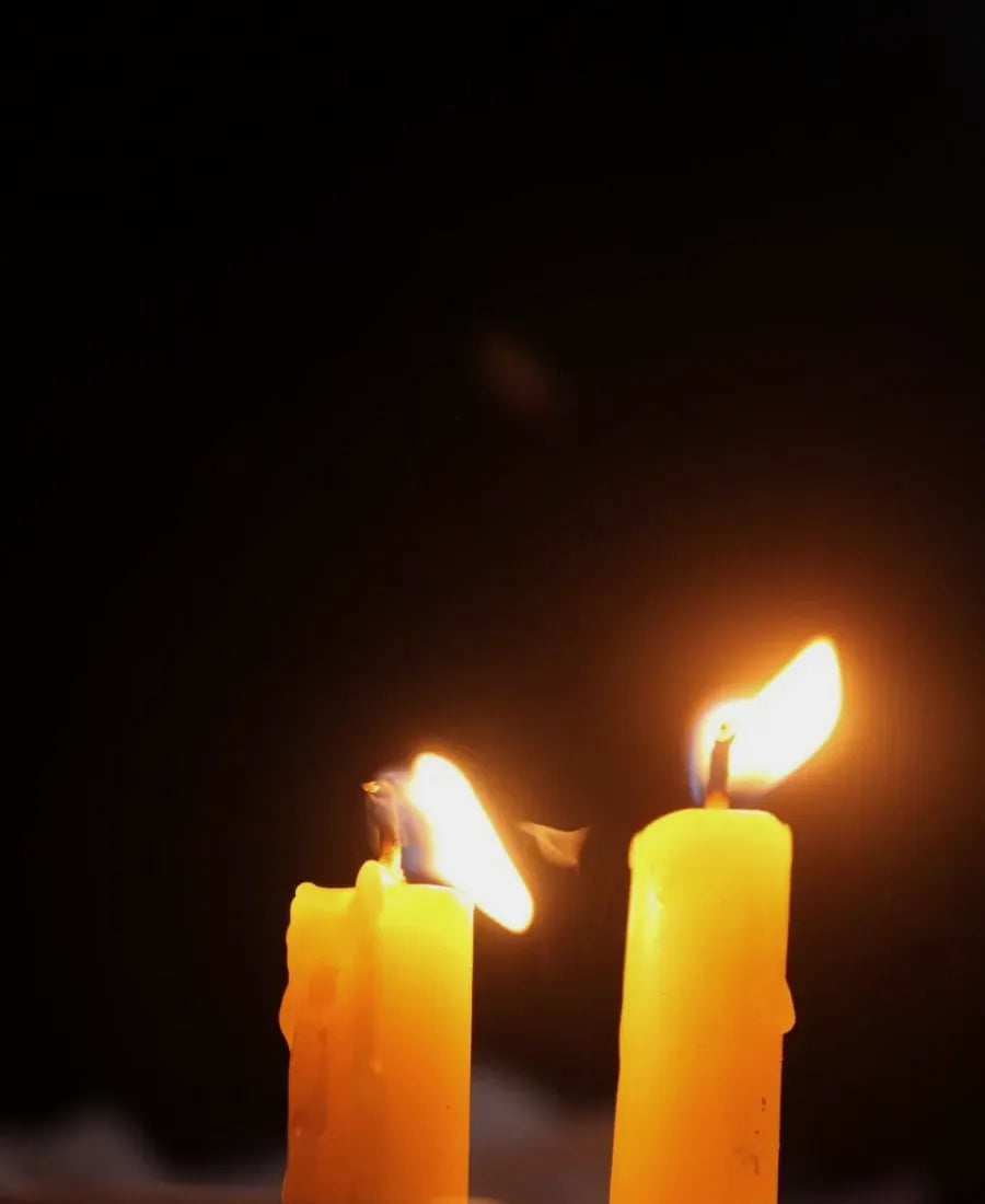 Two candles burning in the dark for an evening ritual